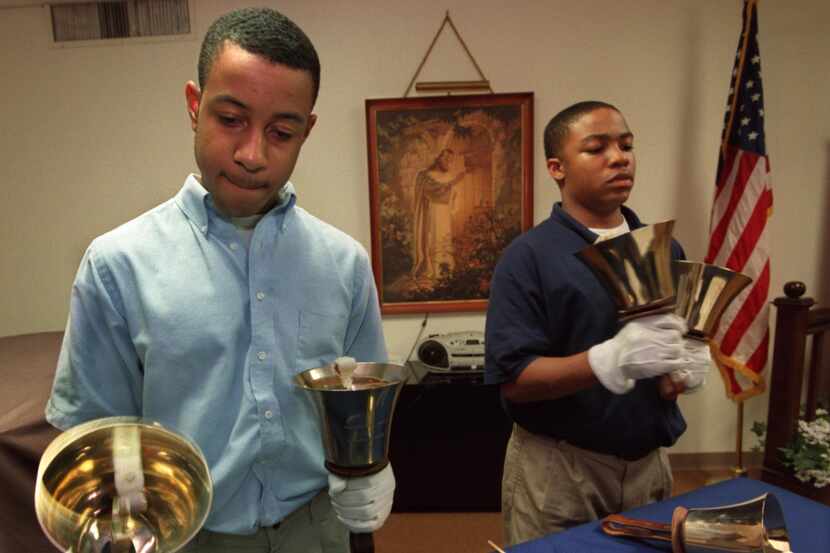 Students at Tyler Street Christian Academy play the bass bells during a music class in this...