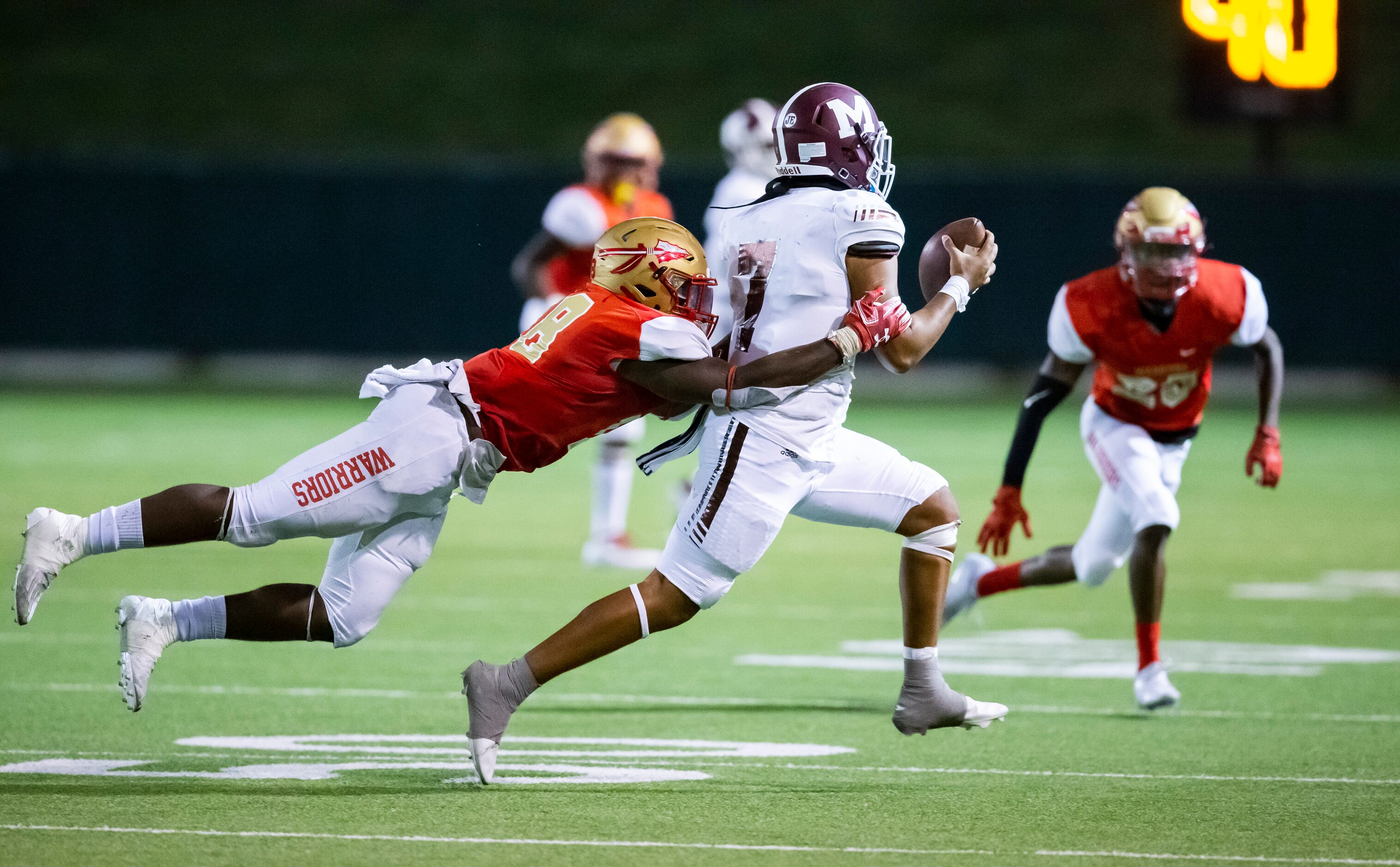 South Grand Prairie senior wide receiver Deamikkio Nathan (8) tackles Mesquite junior...