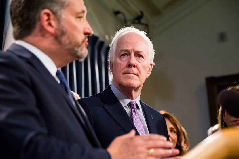 Texas Sen. John Cornyn watches as Sen. Ted Cruz speaks during a press conference at the...
