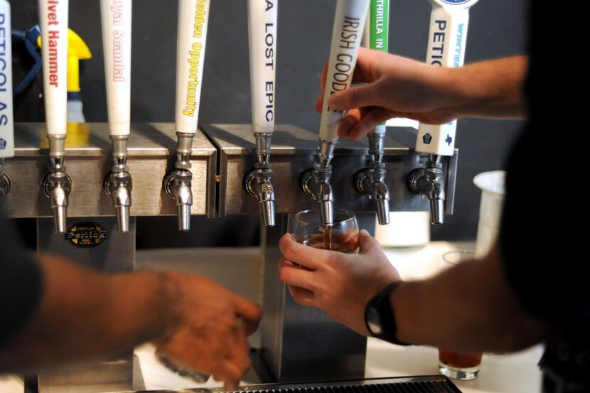 A glass of Irish Goodbye, an Irish Red Ale, was poured at Peticolas Brewing Company's third...