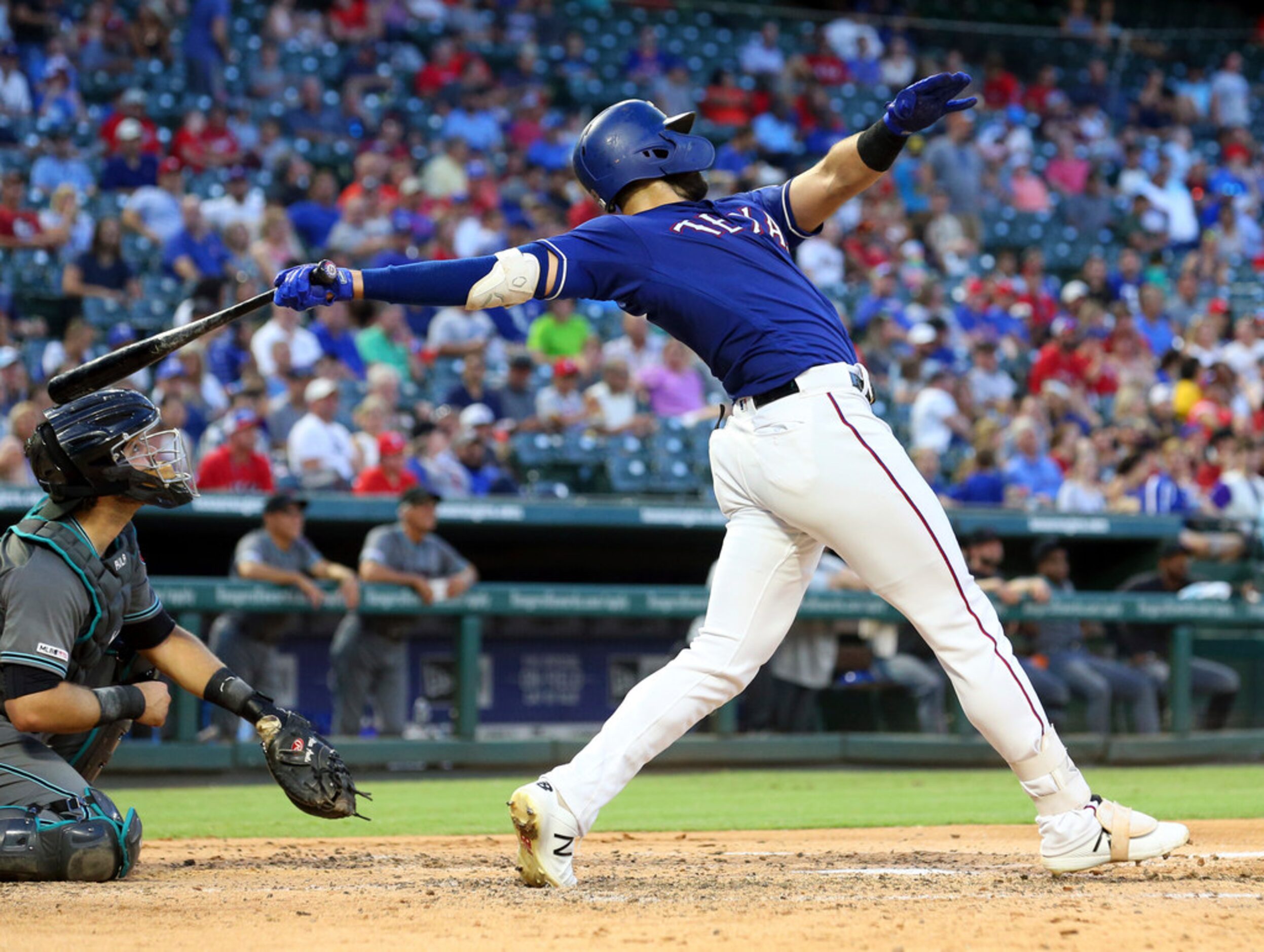 Texas Rangers Joey Gallo (13) follows through on a solo home run in the fourth inning of a...