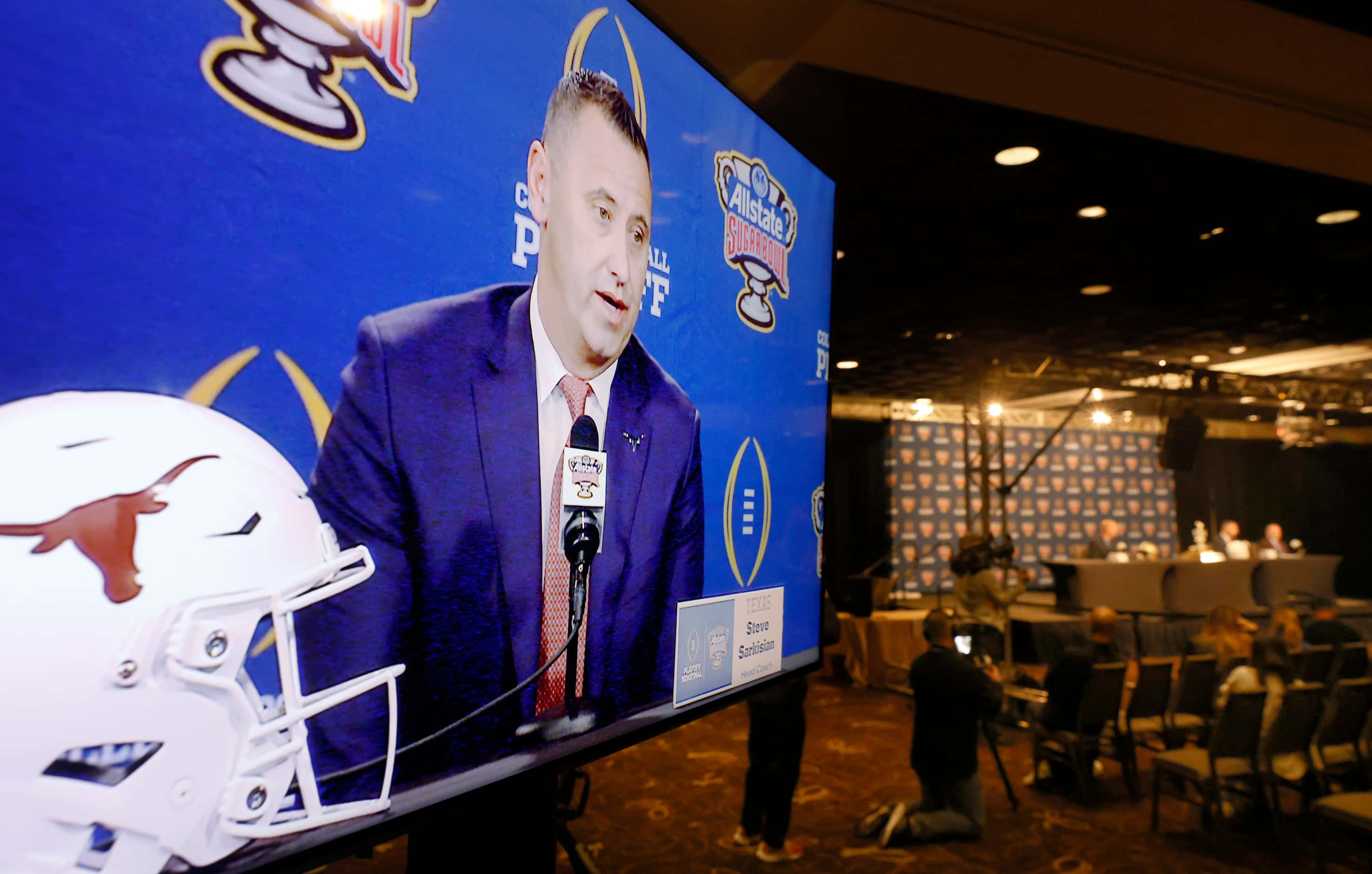 Texas head coach Steve Sarkisian is pictured on an in-house television monitor as he answers...