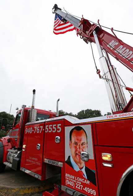 A photo of Brian Loncar is attached to a Big Daddy's Wrecker & Recovery truck outside his...