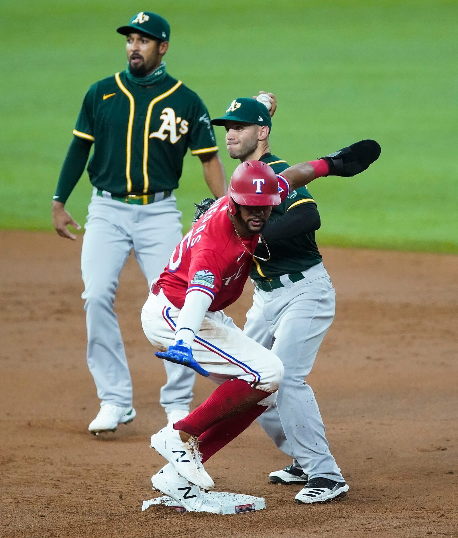 Texas Rangers center fielder Leody Taveras is safe at second base as Oakland Athletics...