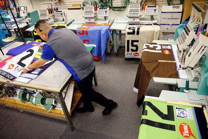 B2B Casuals employee Jose Andrade finishes stitching Kentucky Derby saddle cloths on high...