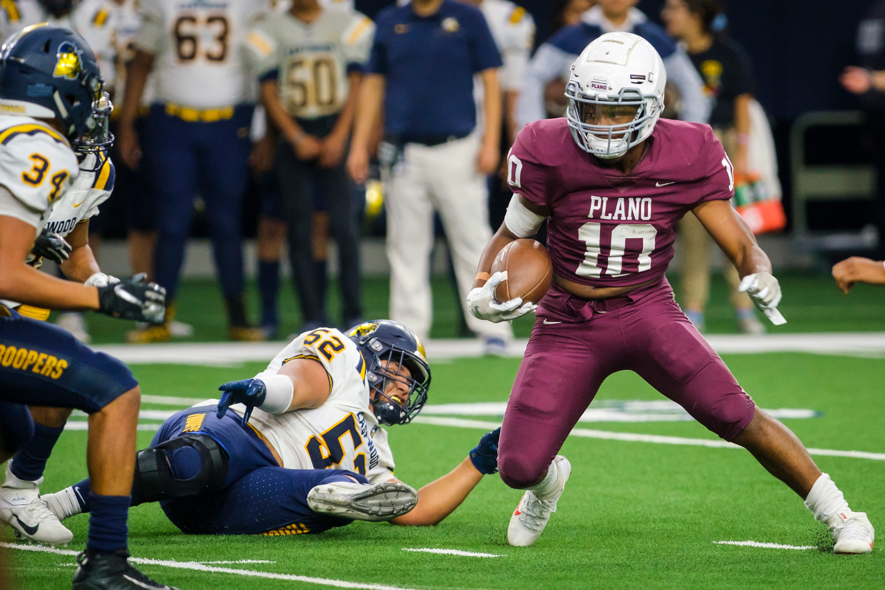 Plano running back C.J. Perry (10) gets past El Paso Eastwood defensive lineman Vincent...