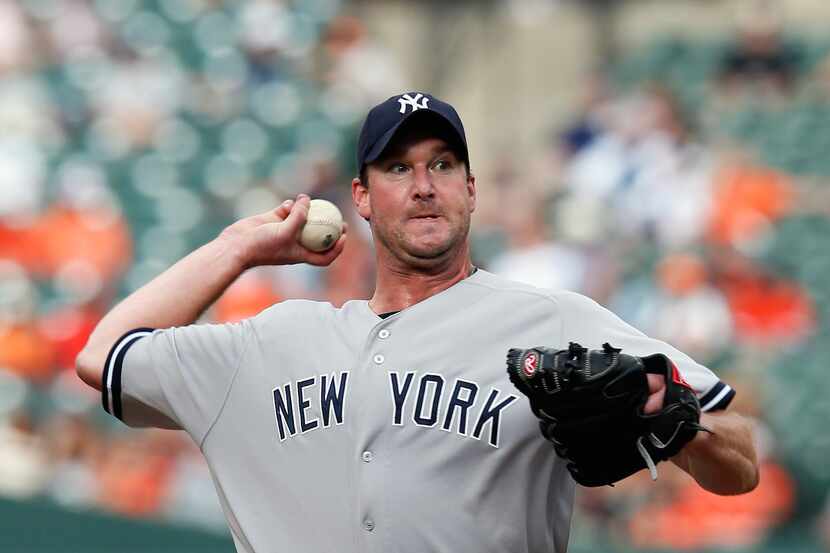 BALTIMORE, MD - SEPTEMBER 09: Pitcher Derek Lowe #34 of the New York Yankees throws to a...