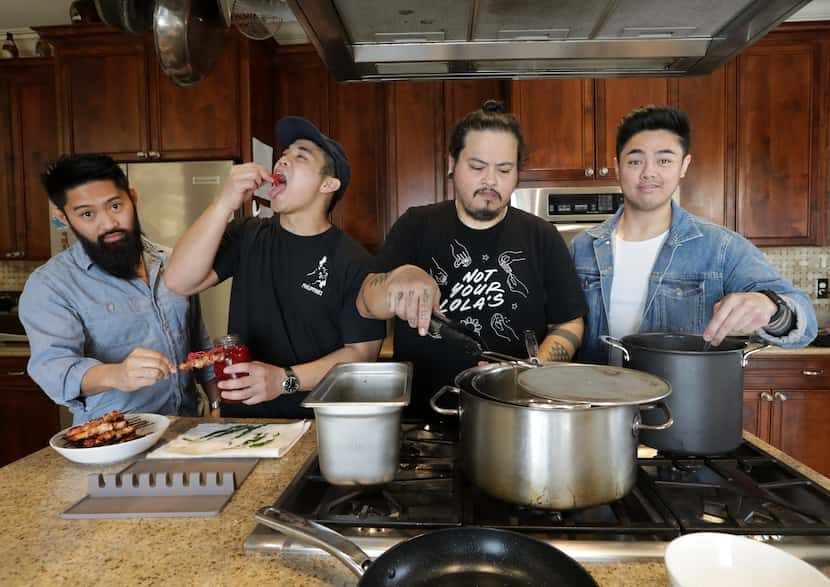 Daniel Gerona, left, Jed Pajela, Randall Braud, and Carlo Wayan create Filipino dishes for...