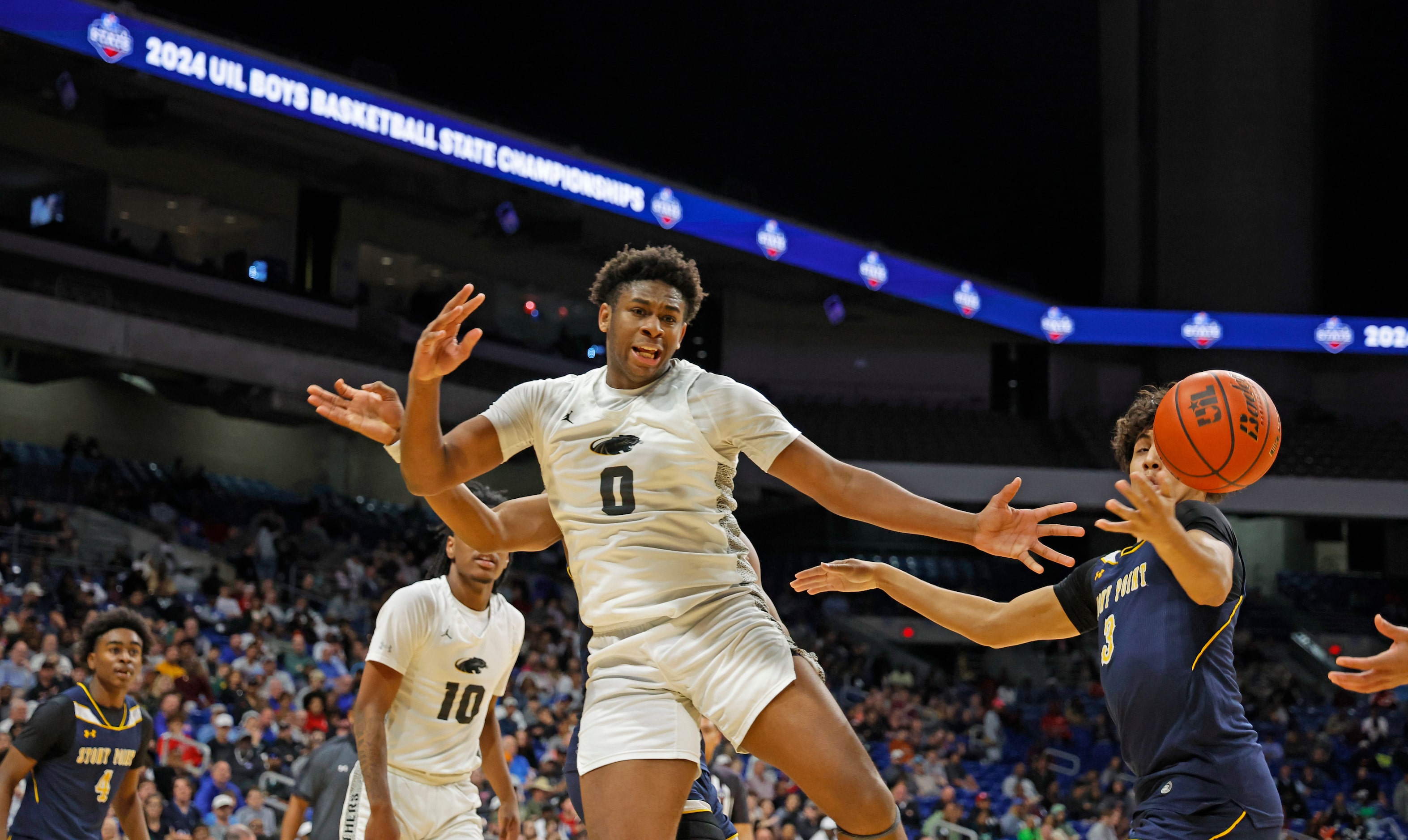 Plano East's DJ Hall (0) reaches for a loose ball in the first half of the UIL Class 6A boys...