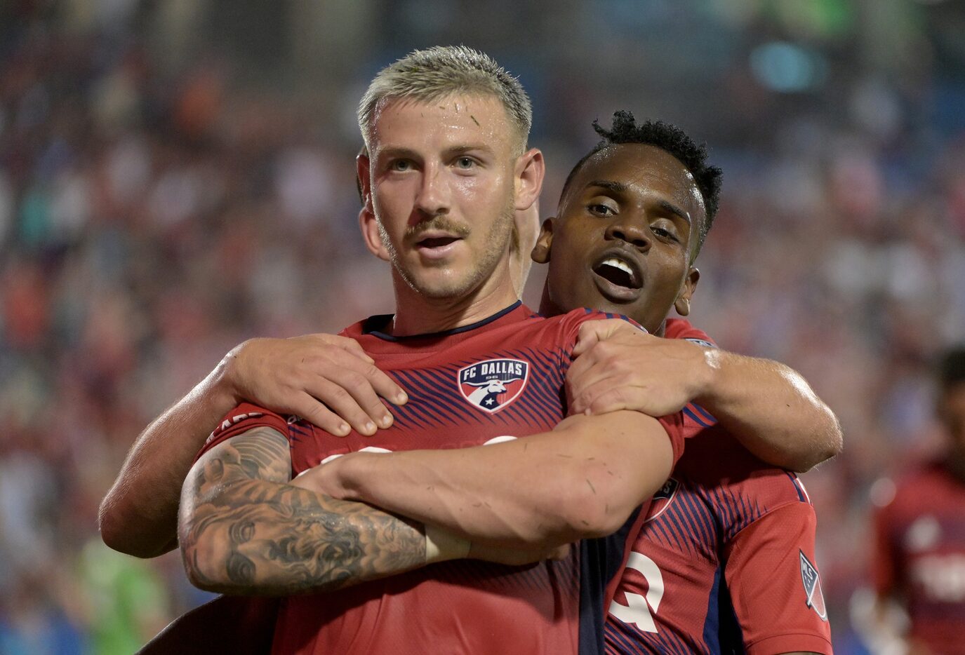 FC Dallas forward Paul Arriola (7) celebrates his goal with  forward Jáder Obrian (8) in the...