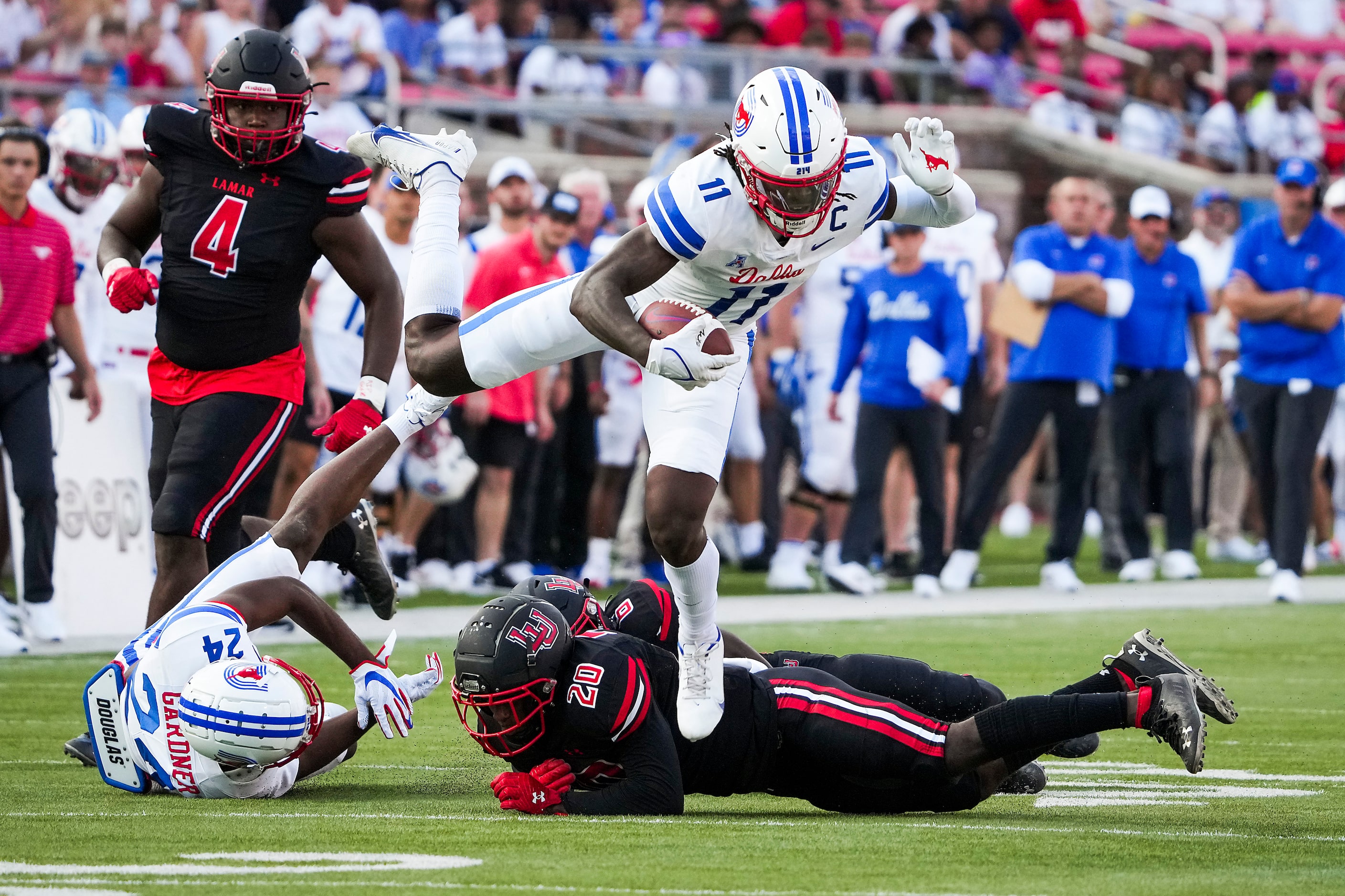 SMU wide receiver Rashee Rice (11) leaps over Lamar Cardinals defensive back Kristian Pugh...