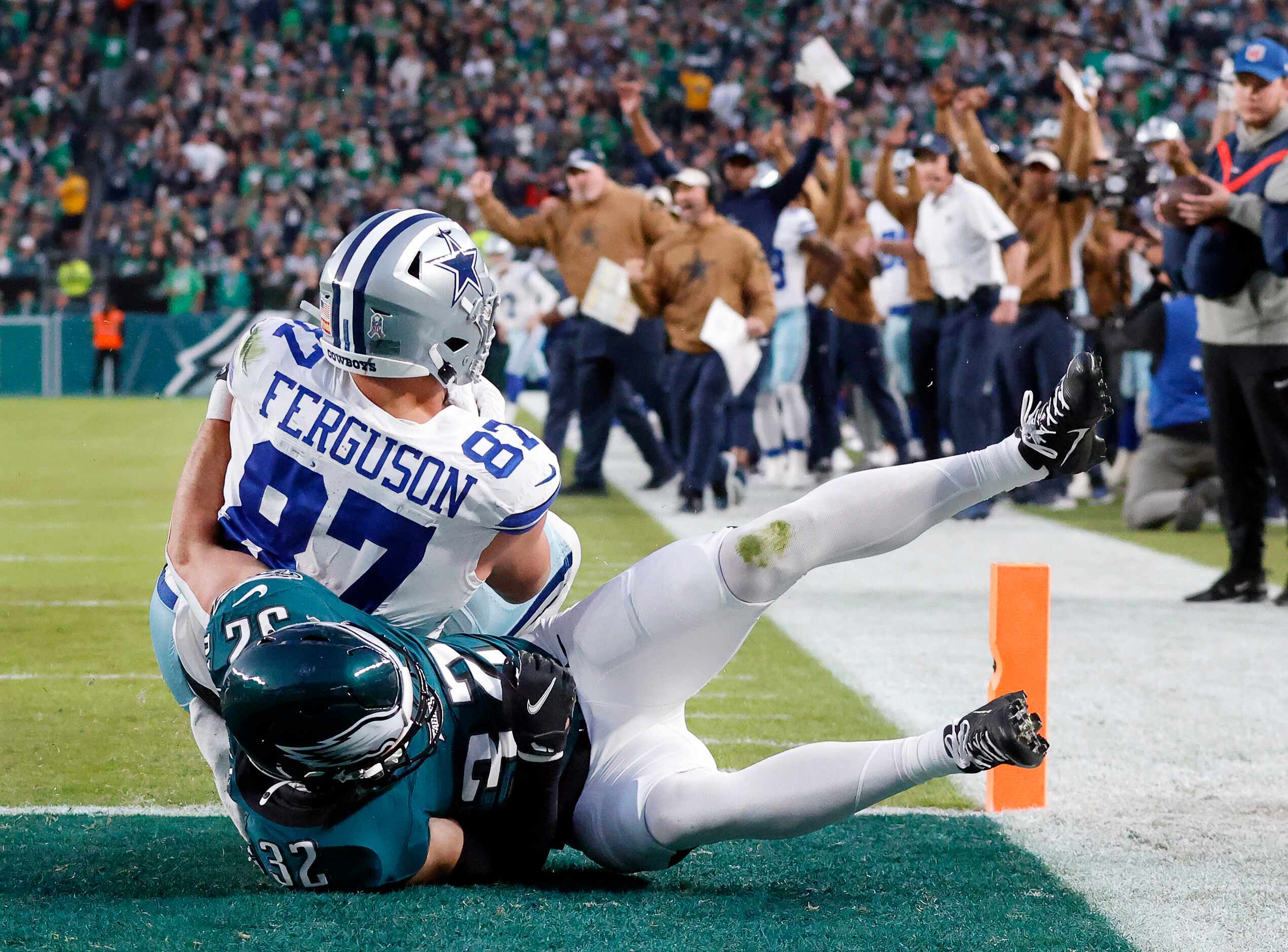Dallas Cowboys tight end Jake Ferguson (87) scores a first quarter touchdown as he’s tackled...