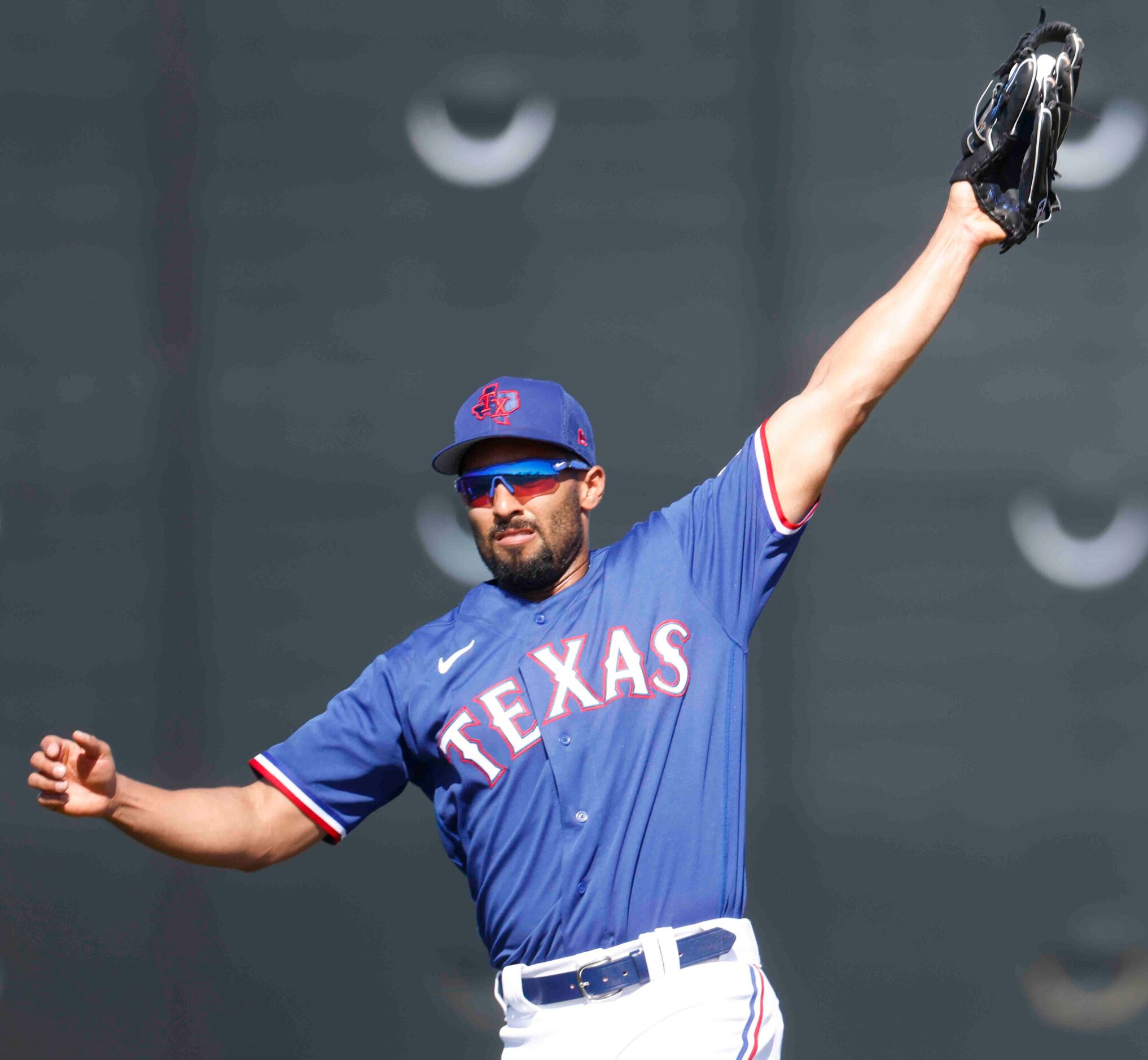 Texas Rangers second baseman Marcus Semien warms up during a spring training workout at the...