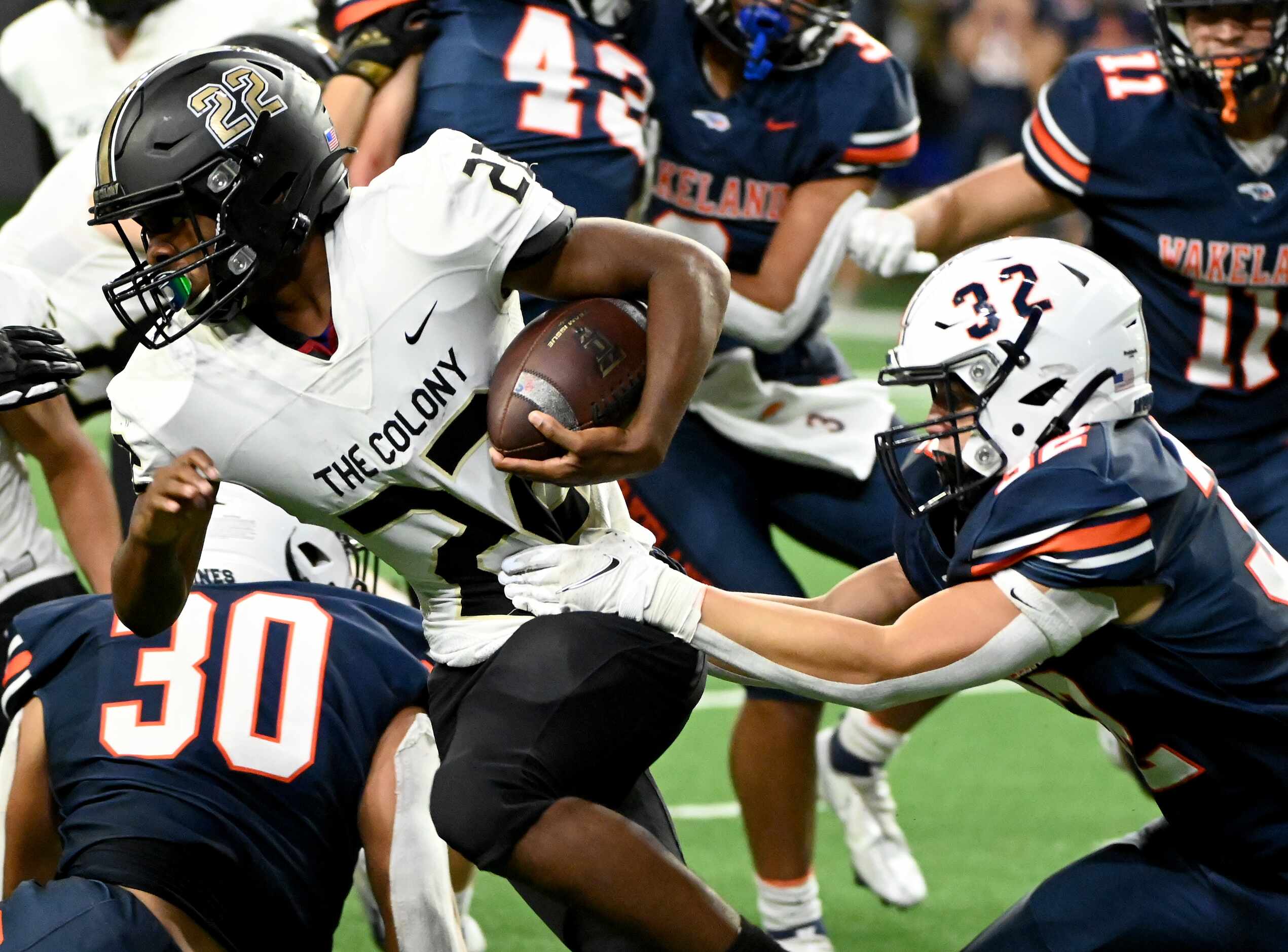 The Colony's Dylan Sneed (22) tries to run through a tackle attempt by Frisco Wakeland's...