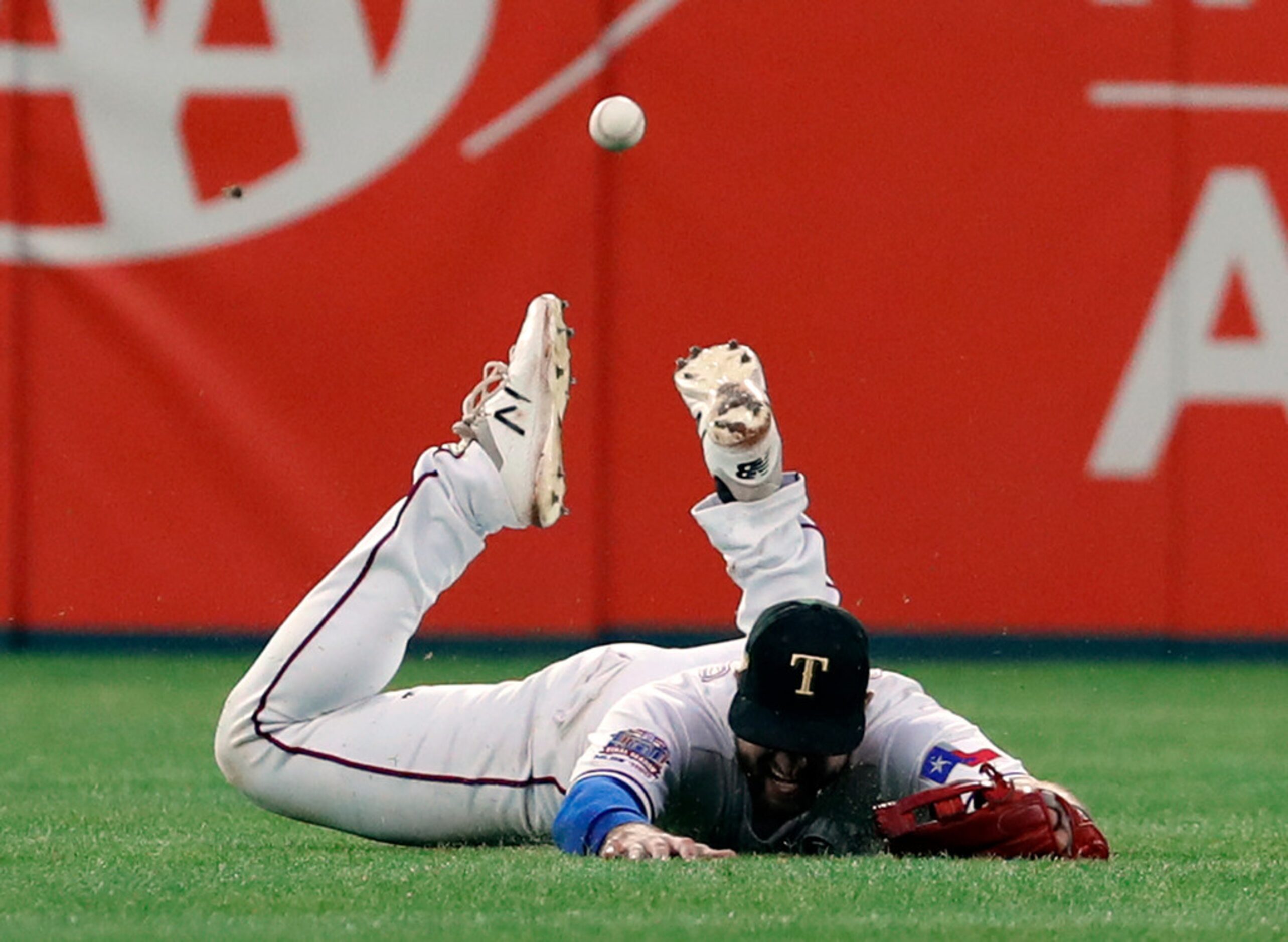 Texas Rangers center fielder Joey Gallo hits the ground hard while chasing a double by St....