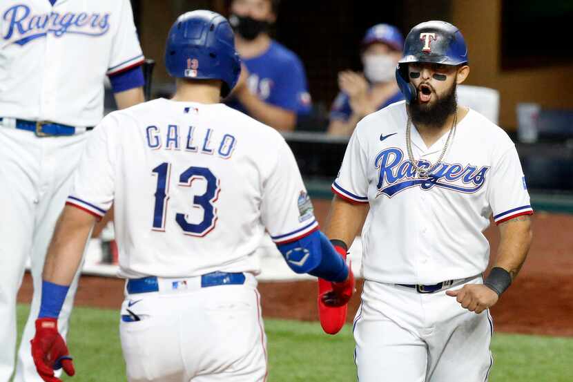 Texas Rangers Joey Gallo (13) is congratulated by teammate Rougned Odor after hitting a...