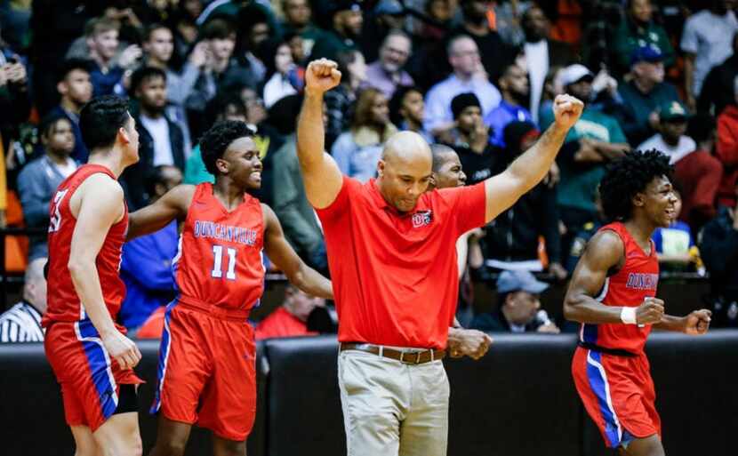 Duncanville head coach David Peavy, third from left, and his team celebrate a 61-60 overtime...