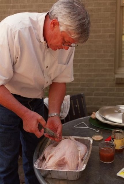 John Bass demonstrates how to fry a turkey.