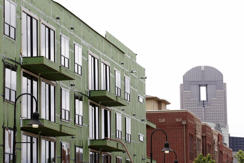 
Alta Farmers Market Apartments, left, under construction near Downtown Dallas on May 12,...