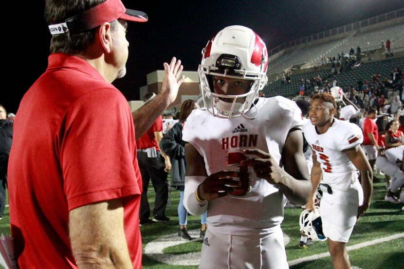 Mesquite Horn QB Jermaine Givens (3) gets a pat on the head from a coach at the end of a...