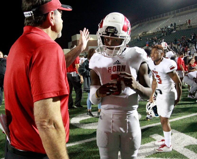 Mesquite Horn QB Jermaine Givens (3) gets a pat on the head from a coach at the end of a...