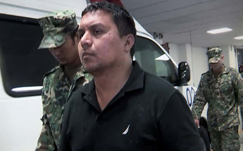 Zetas cartel leader Miguel Angel Trevino Morales is escorted by Mexican marines after his...
