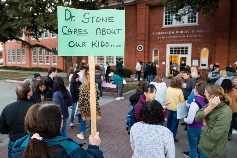 Terry Kopel, a concerned parent, held a sign supporting Dr. Jeannie Stone as supporters...