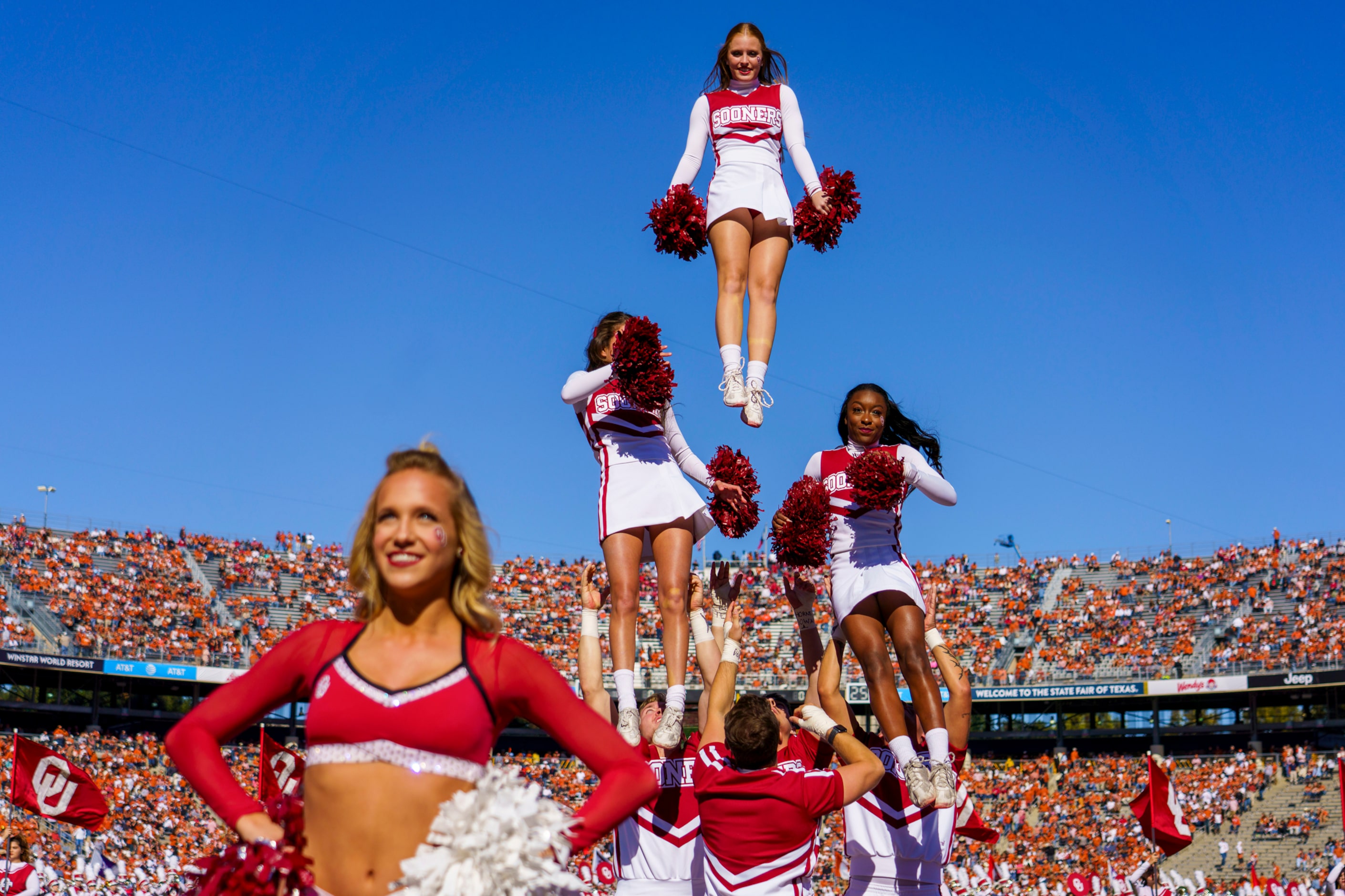 Oklahoma cheerleaders perform before an NCAA football game against Texas at the Cotton Bowl...