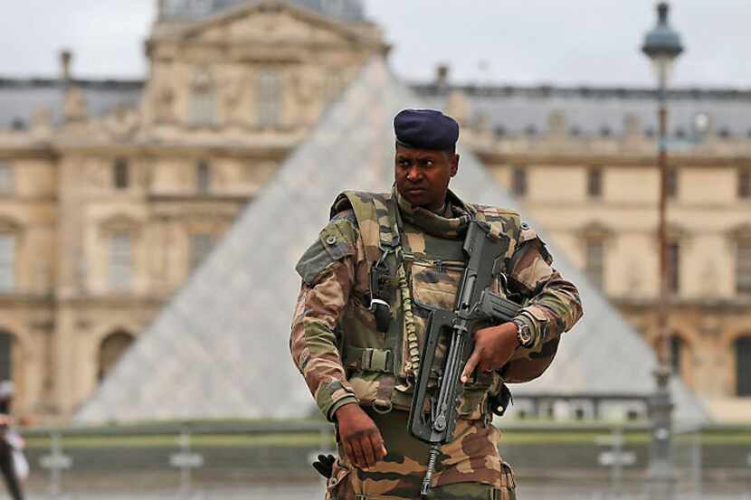 A French soldier patrols in the courtyard of the Louvre Museum Tuesday in Paris. France made...