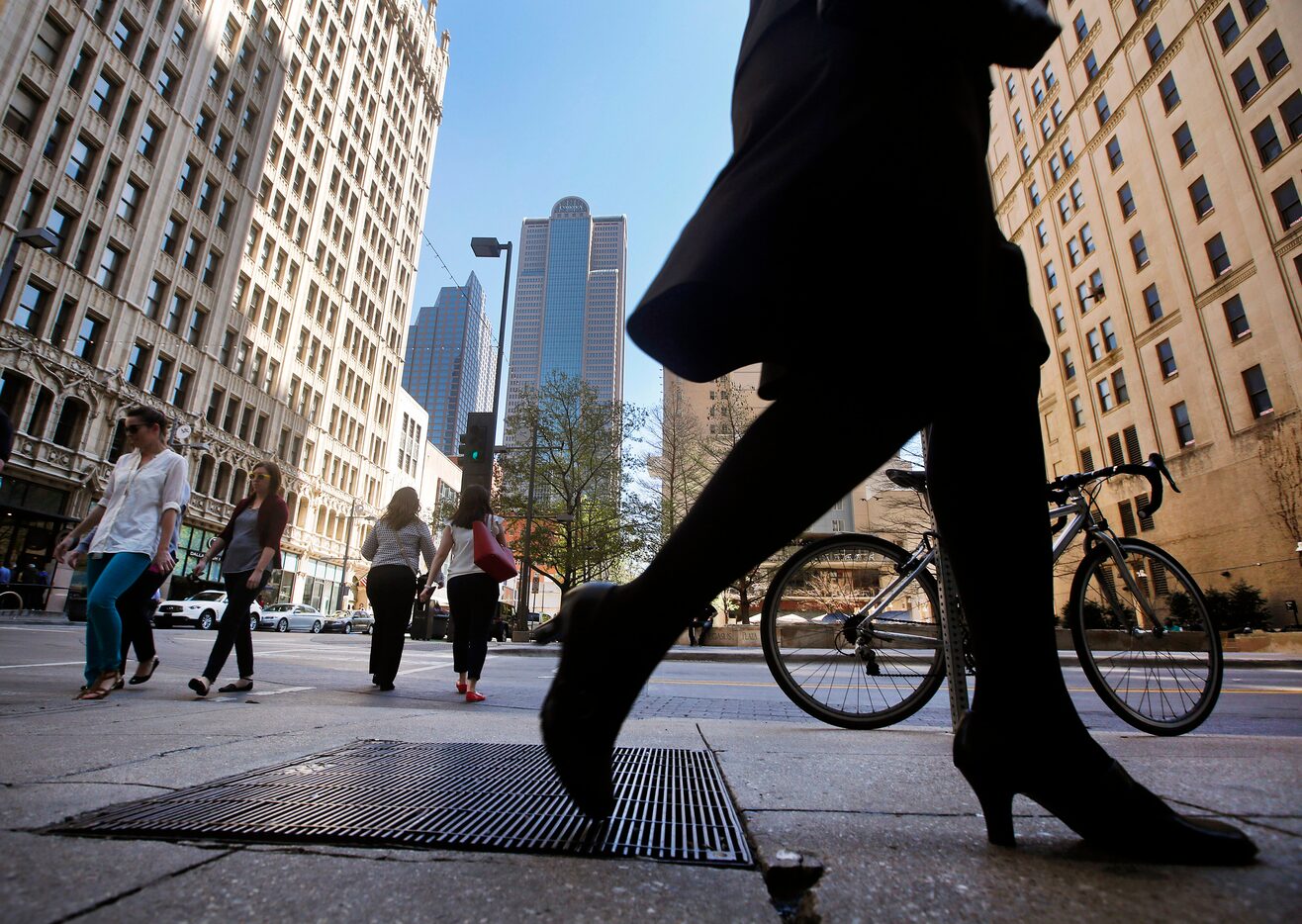 Lunchtime traffic is steady along Main Street at Akard Street in downtown Dallas. 