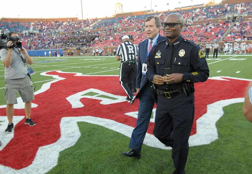 Dallas Police Chief David Brown conducts the coin toss as Texas Christian visits Southern...