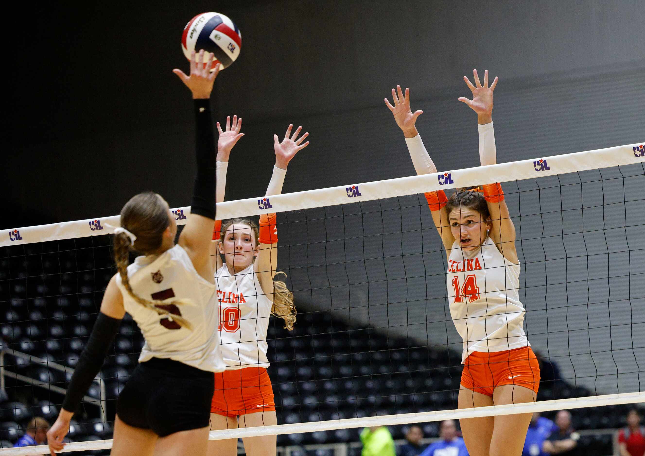 Celina's Ashley Woodrum (10) and Celina's Kennedy Hangartner (14) try to block a spike by...