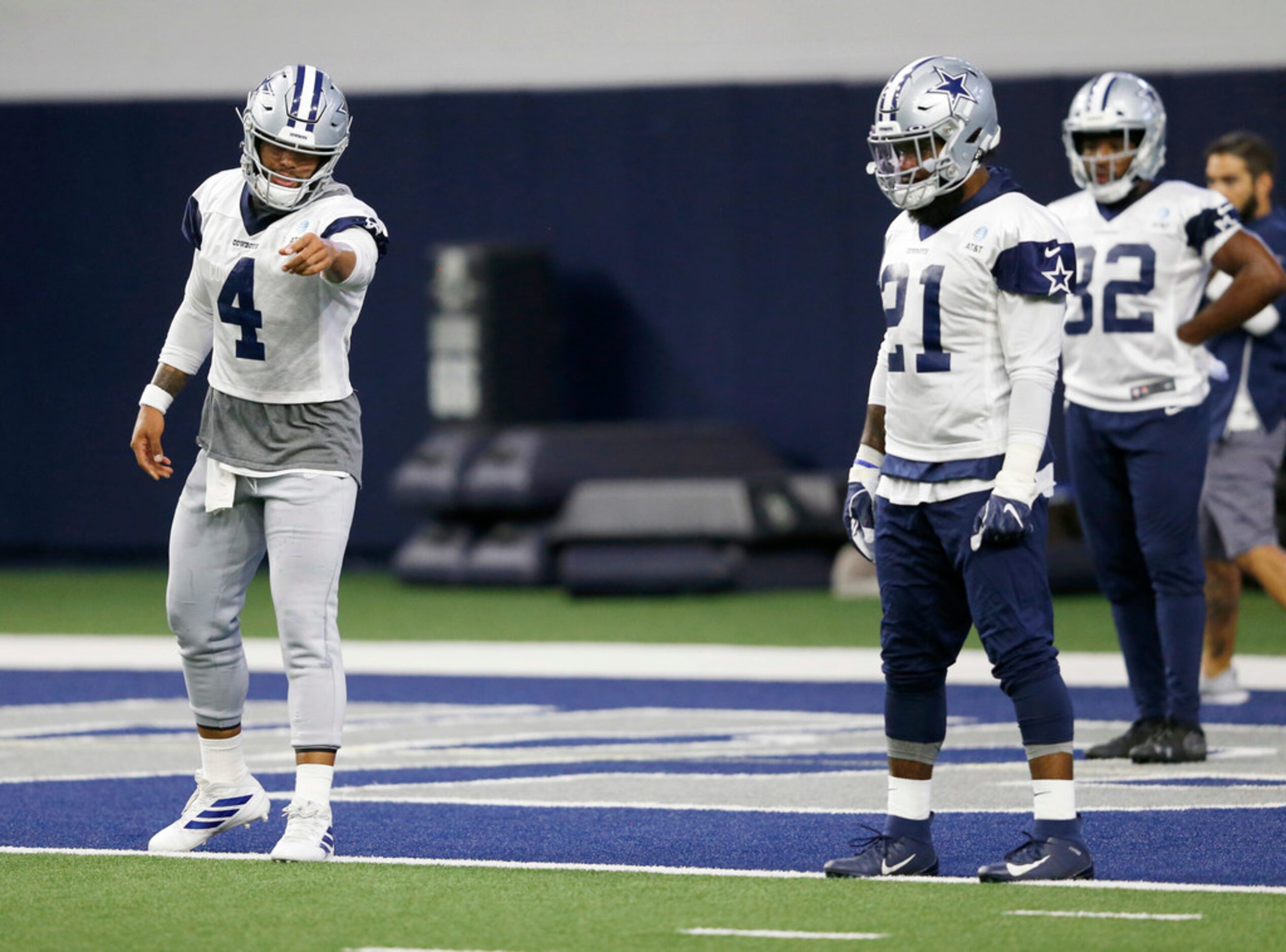 Dallas Cowboys quarterback Dak Prescott (4) talkss with Dallas Cowboys running back Ezekiel...