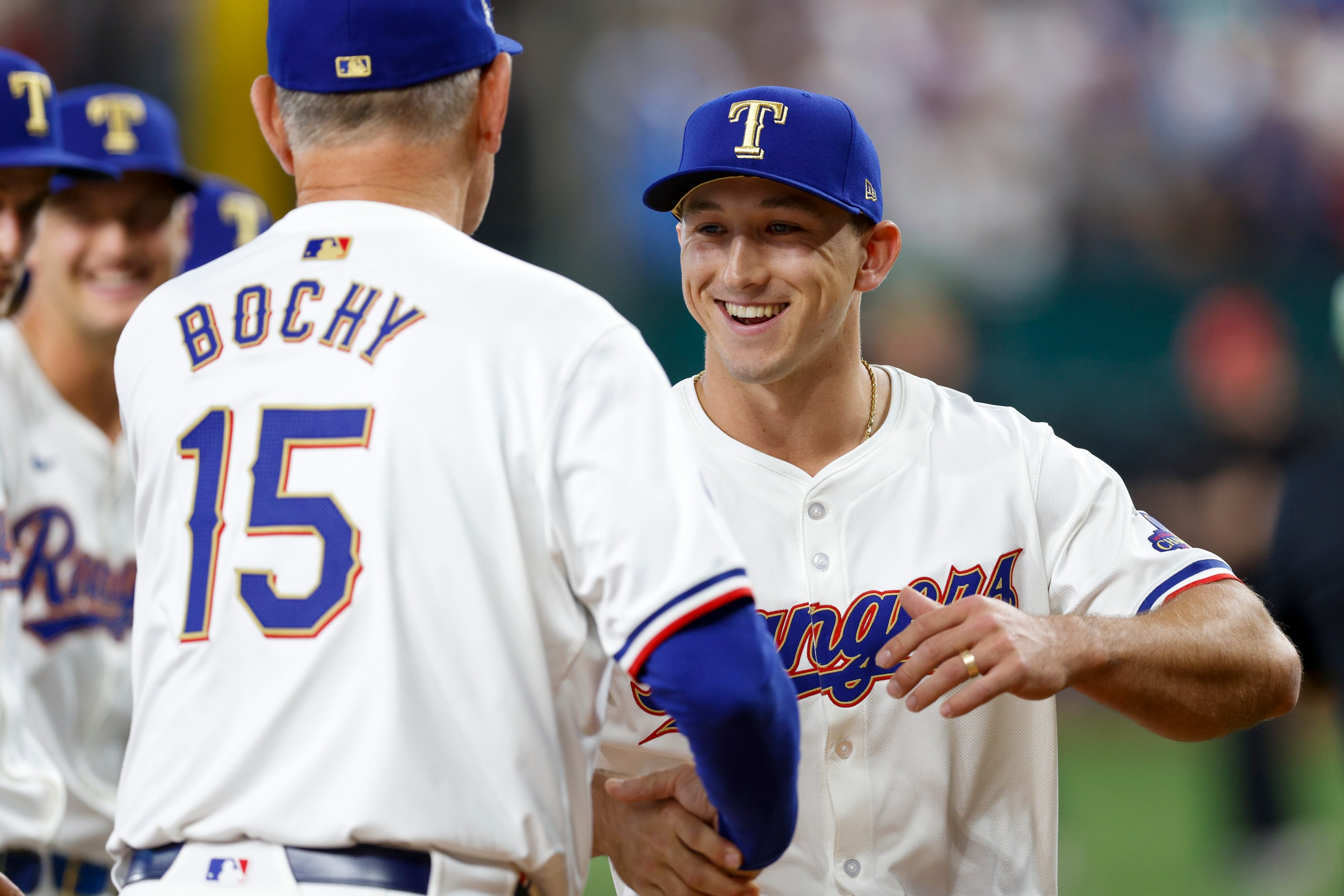 Texas Rangers designated hitter Wyatt Langford (36) greets Texas Rangers manager Bruce Bochy...