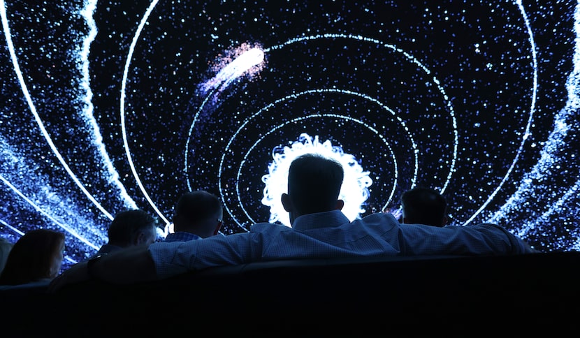 Guests take in an immersive experience projected at Cosm, the big immersive dome venue, as...