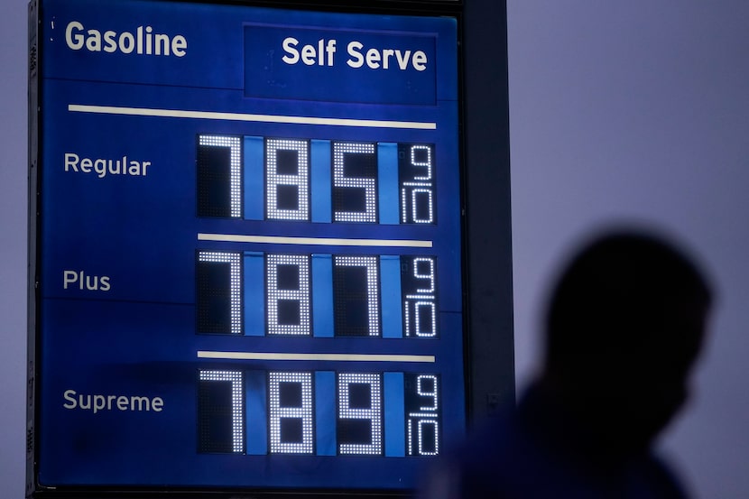 High gas prices are shown as a pedestrian waited to cross the street in Los Angeles in June....