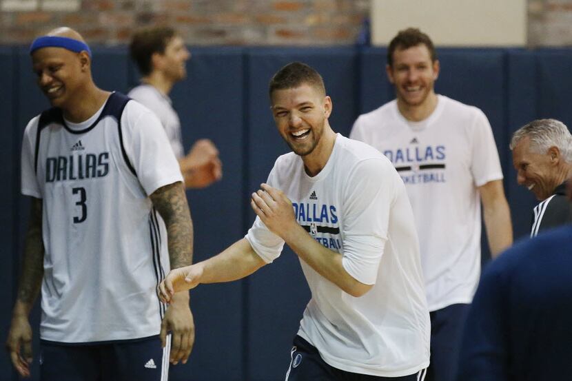 Dallas Mavericks forward Chandler Parsons (center) jokes with teammates while practicing on...