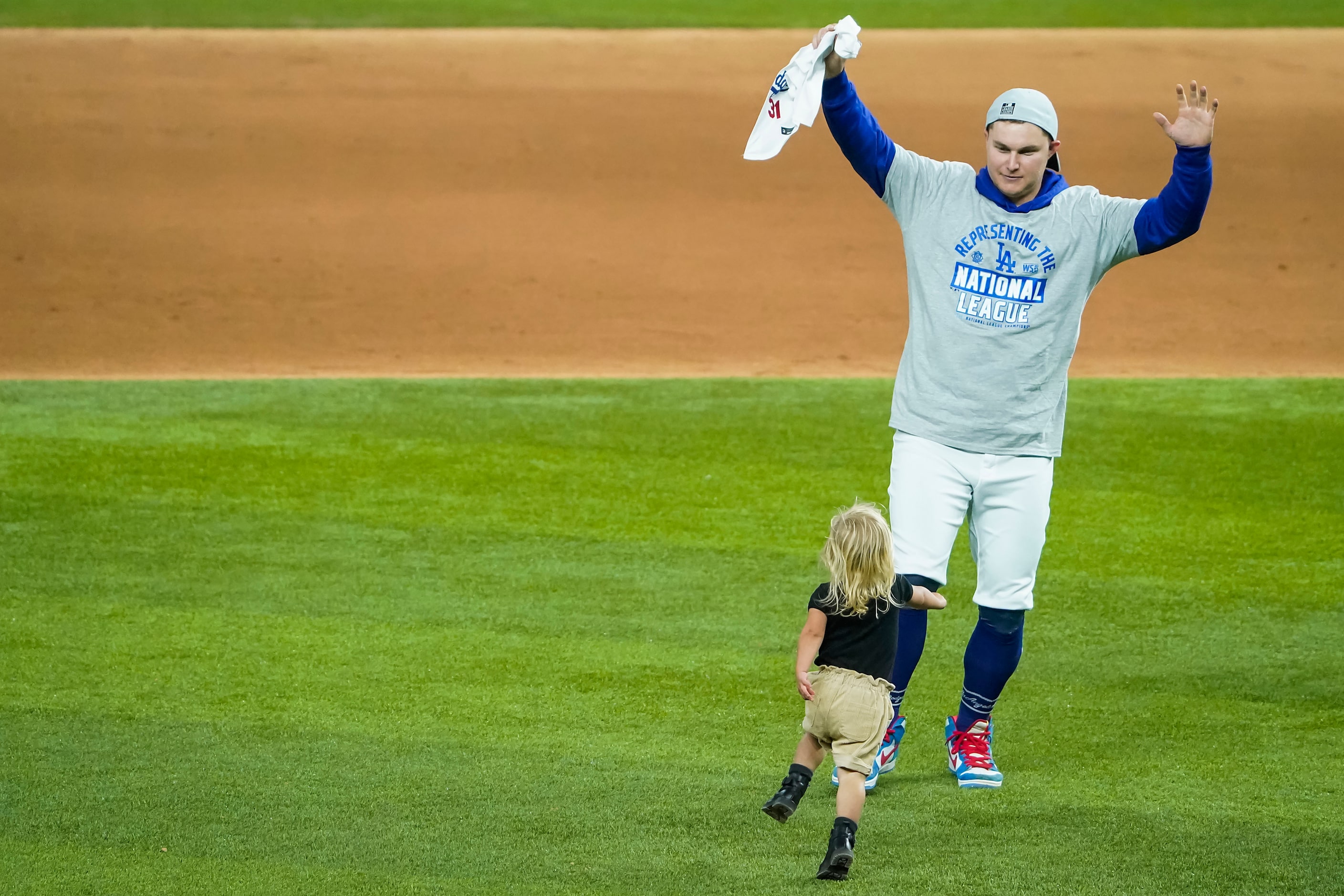 Los Angeles Dodgers designated hitter Joc Pederson celebrates on the field with his children...