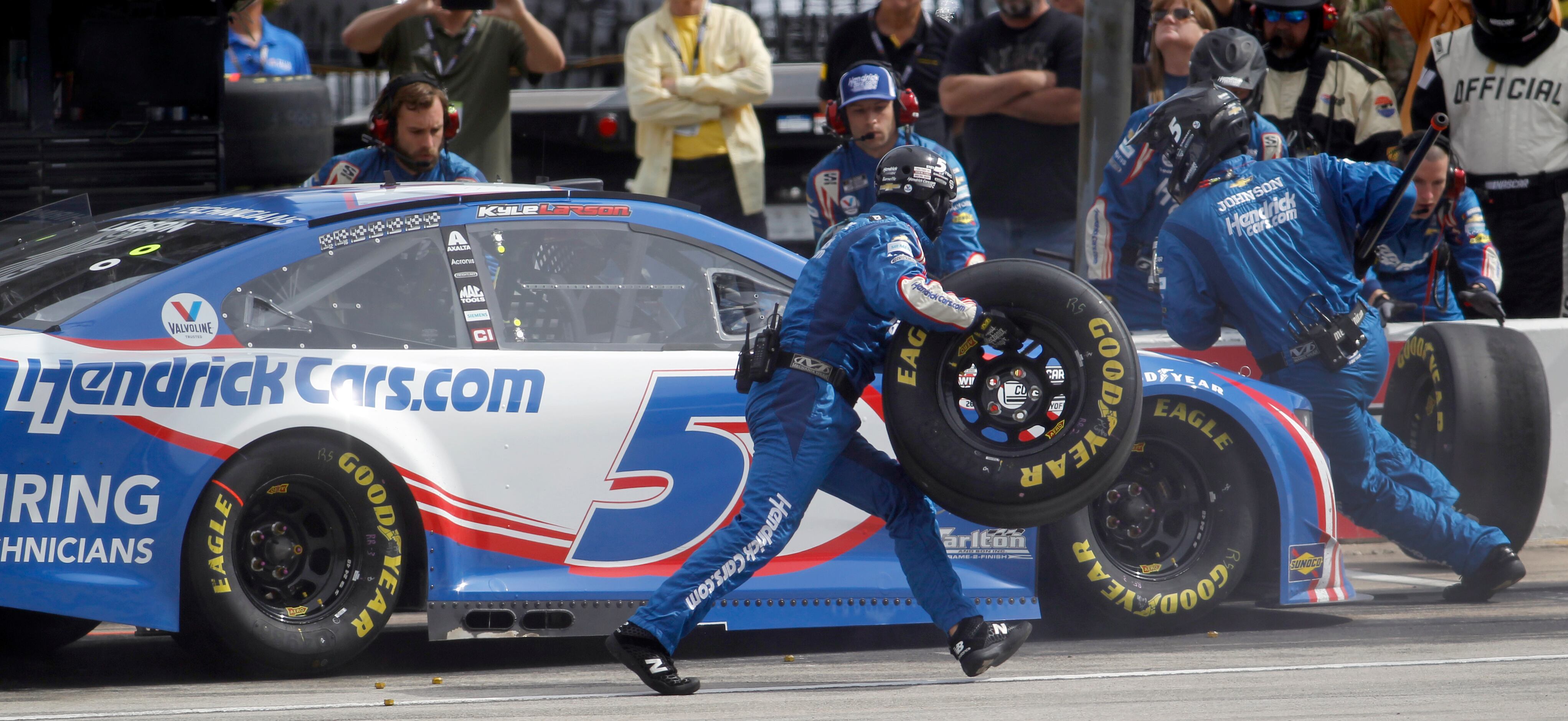 Driver Kyle Larson waits in a pit stop during the 2nd stage of the race as his pit crew...