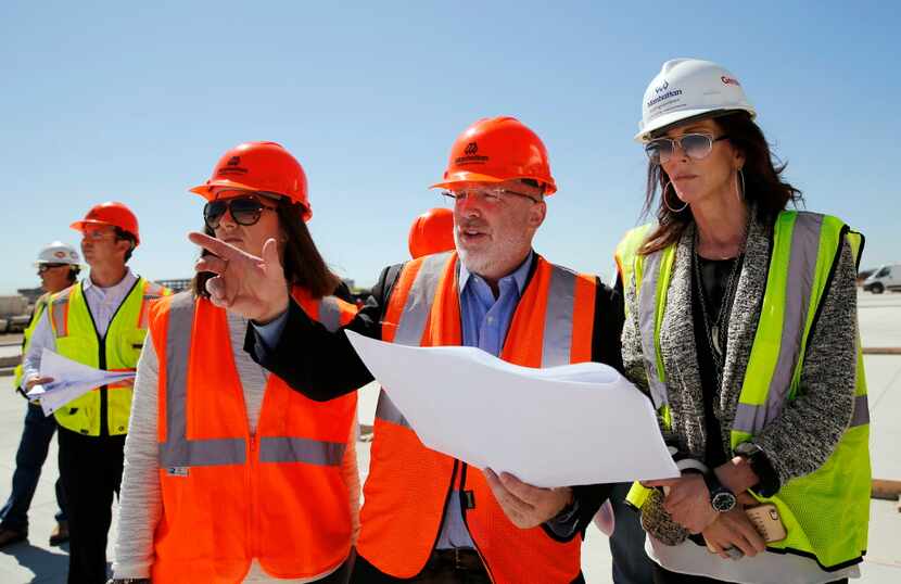 Harry Mark (center), FAIA of RSM Design points out one of the signs to Charlotte Jones...