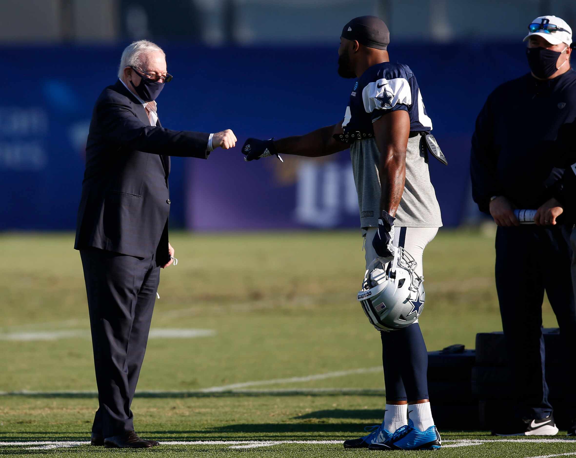 Dallas Cowboys owner and general manager Jerry Jones talks with Dallas Cowboys defensive end...