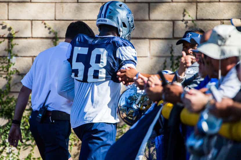 Dallas Cowboys defensive end Robert Quinn (58) leaves practice with a hand injury during an...