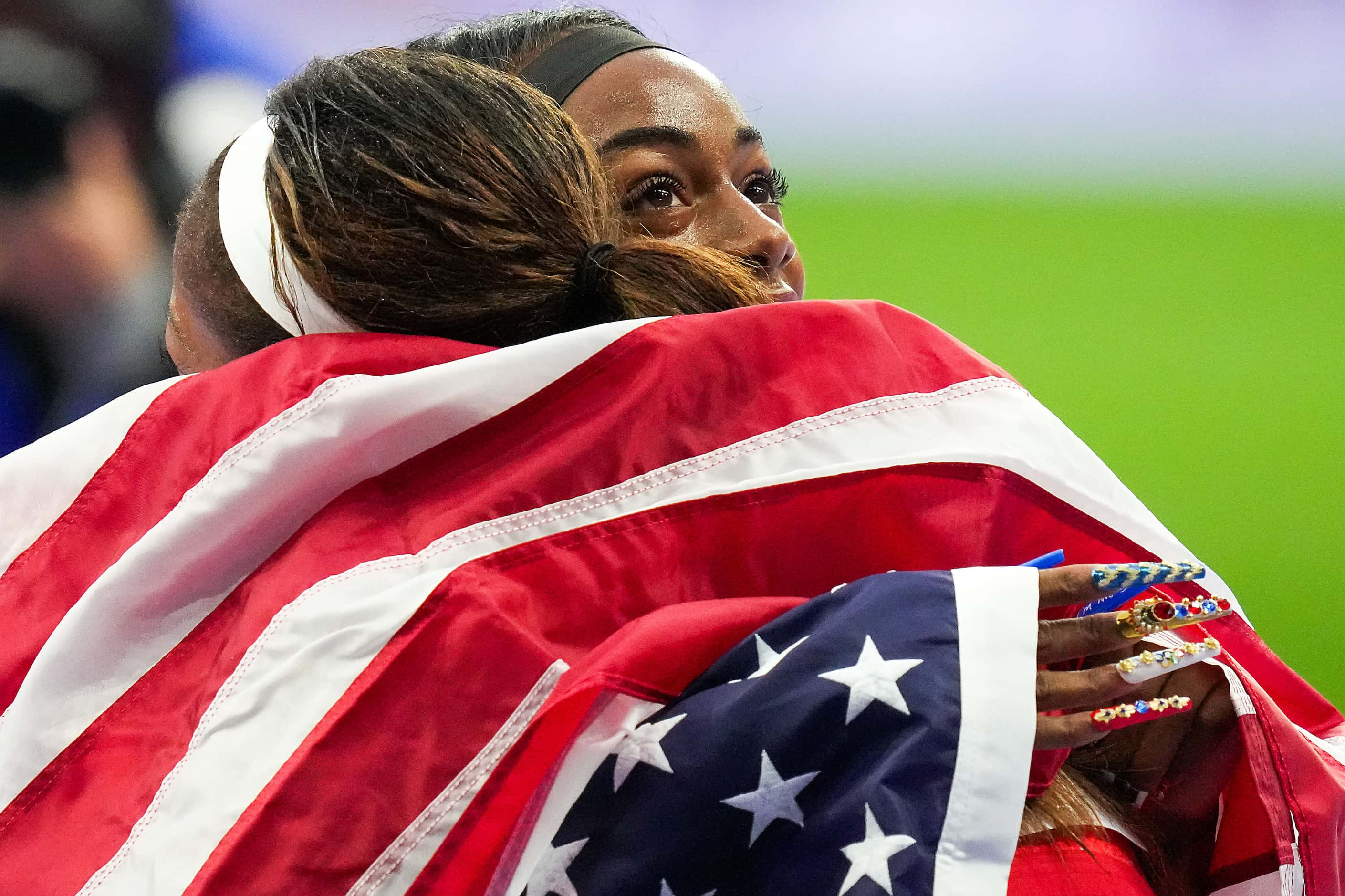 Sha'carri Richardson of the United States hugs teammate Gabrielle Thomas after winning the...