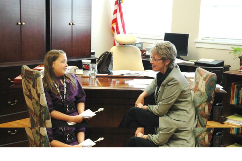 RISD superintendent Kay Waggoner talks with Emily Norton, a student who was principal for a...
