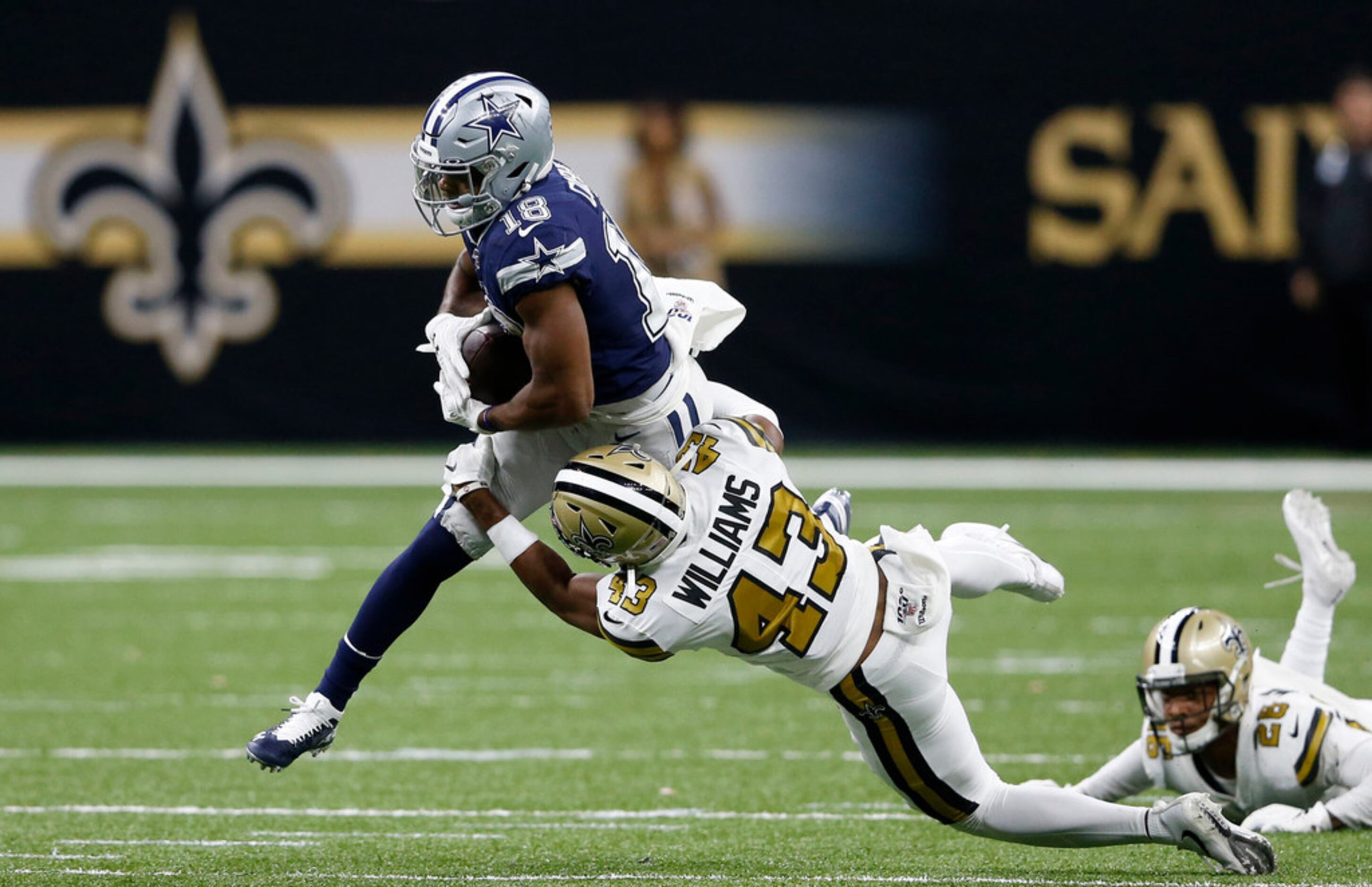 Dallas Cowboys wide receiver Randall Cobb (18) is tackled by New Orleans Saints free safety...