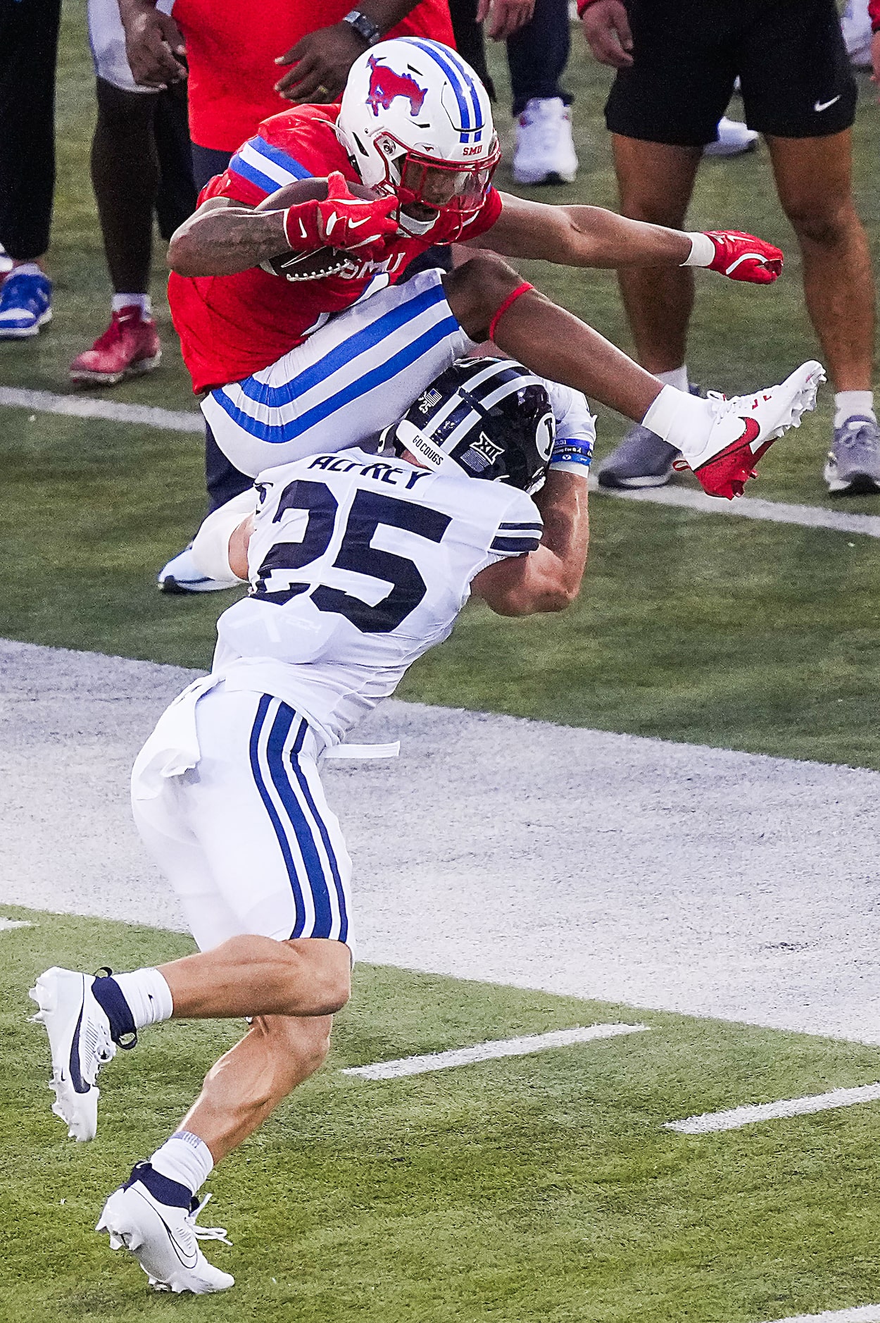 SMU running back Jaylan Knighton (4) tries to hurdle BYU safety Talan Alfrey (25) during the...