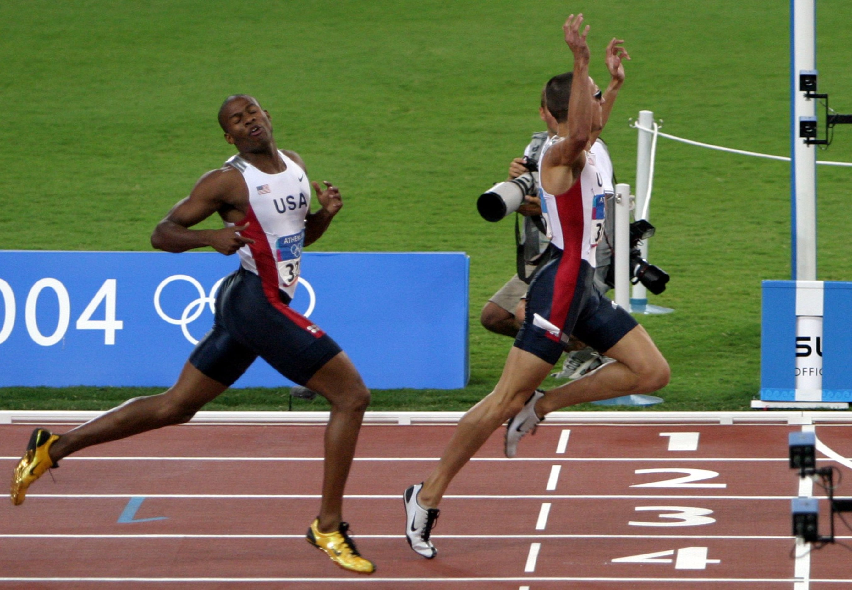 2004 Summer Olympic Games: Jeremy Wariner of the U.S. (R) beats teammate Otis Harris to the...