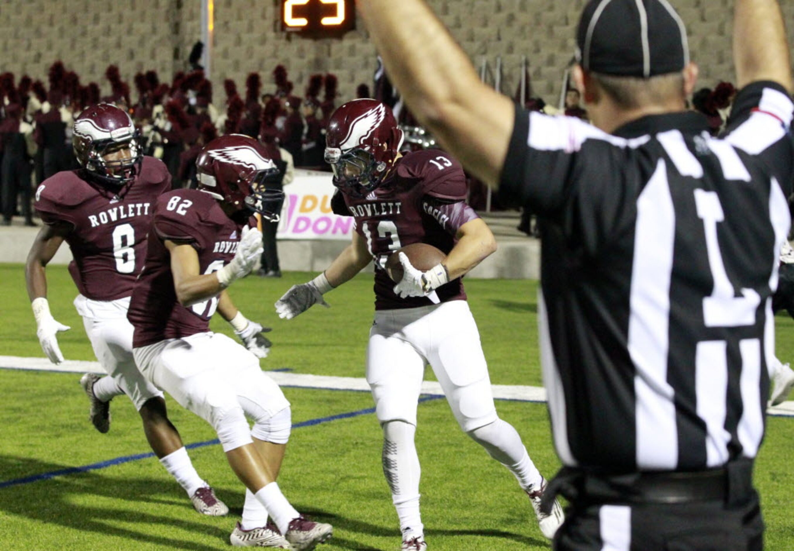 (TXHSFB) Rowlett's Quinton Stinson (8); Cameron Vitosh (82) and Dylan Watts (13) celebrate...