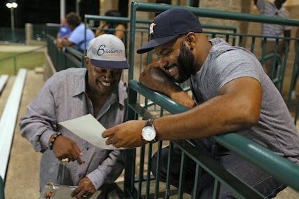 During filming of "Carter High" in Grand Prairie, actor Charles Dutton (left) shows producer...