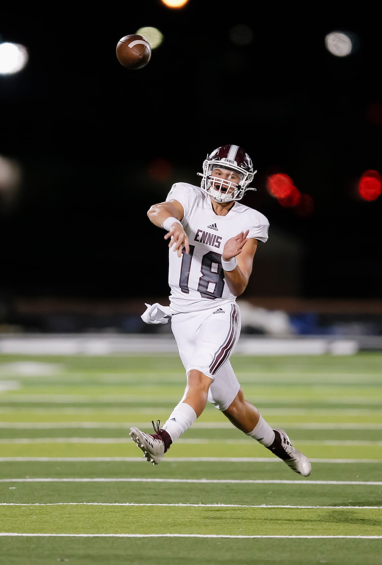 Ennis senior quarterback Collin Drake throws during the first half of a high school playoff...